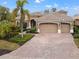 Spacious home exterior, three-car garage and a large brick driveway at 7033 Brier Creek Ct, Lakewood Ranch, FL 34202