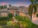 Elegant home with a welcoming entrance and lush landscaping at dusk at 7033 Brier Creek Ct, Lakewood Ranch, FL 34202