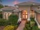 Beautiful two-story home with brick walkway and lush landscaping at 7033 Brier Creek Ct, Lakewood Ranch, FL 34202