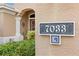 House number 7033, address marker on stucco wall at 7033 Brier Creek Ct, Lakewood Ranch, FL 34202