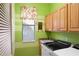 Laundry room with washer, dryer, and ample cabinet storage at 7033 Brier Creek Ct, Lakewood Ranch, FL 34202