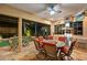 Outdoor kitchen and dining area with a view of the pool at night at 7033 Brier Creek Ct, Lakewood Ranch, FL 34202
