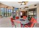 Covered outdoor kitchen with built-in grill, seating area, and view to backyard at 7033 Brier Creek Ct, Lakewood Ranch, FL 34202