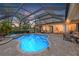 Stunning pool and spa at night with beautiful lighting and landscaping at 7033 Brier Creek Ct, Lakewood Ranch, FL 34202