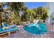 Inviting kidney-shaped pool surrounded by lush landscaping at 730 Holly Rd, Anna Maria, FL 34216