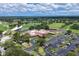 Aerial view of the property showcasing the golf course, clubhouse, and surrounding lush landscaping at 7422 W Country Club N Dr, Sarasota, FL 34243