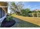 Landscaped backyard featuring flower beds and healthy lawn at 7422 W Country Club N Dr, Sarasota, FL 34243