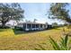 Landscaped backyard featuring flower beds and healthy lawn at 7422 W Country Club N Dr, Sarasota, FL 34243