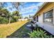 Landscaped backyard featuring flower beds and healthy lawn at 7422 W Country Club N Dr, Sarasota, FL 34243