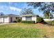 Charming single-story home featuring a well-manicured lawn and neatly trimmed hedges at 7422 W Country Club N Dr, Sarasota, FL 34243