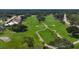 Aerial view of the lush green golf course featuring mature trees and meticulously maintained fairways at 7422 W Country Club N Dr, Sarasota, FL 34243