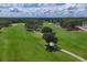 Scenic golf course view with rolling greens, mature trees, and a meandering path under a cloudy sky at 7422 W Country Club N Dr, Sarasota, FL 34243