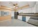 Clean kitchen with modern appliances, white cabinets, and tiled backsplash at 7422 W Country Club N Dr, Sarasota, FL 34243