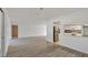 Open-concept layout with gray floors connecting to the kitchen at 7422 W Country Club N Dr, Sarasota, FL 34243