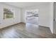Living room with gray floors and view of the enclosed sunroom at 7422 W Country Club N Dr, Sarasota, FL 34243