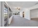 Enclosed sunroom with carpet and large windows providing natural light at 7422 W Country Club N Dr, Sarasota, FL 34243