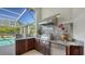 Modern outdoor kitchen with stainless steel appliances at 7822 Allen Robertson Pl, Sarasota, FL 34240