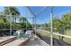 Relaxing screened pool area with lounge chairs and pond view at 7822 Allen Robertson Pl, Sarasota, FL 34240