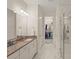 Elegant bathroom with a walk-in shower and double vanity at 8669 Rain Song Rd, Sarasota, FL 34238