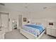 Spacious bedroom with a large bed and ensuite bathroom at 8669 Rain Song Rd, Sarasota, FL 34238