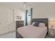 Cozy bedroom with a full bed and a built-in dresser at 8669 Rain Song Rd, Sarasota, FL 34238