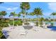 Inviting fire pit area with white Adirondack chairs at 8669 Rain Song Rd, Sarasota, FL 34238