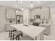 Spacious kitchen boasts modern gray cabinets, white quartz countertops, and stainless steel appliances at 8669 Rain Song Rd, Sarasota, FL 34238