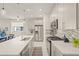 Modern kitchen with stainless steel appliances, an island with seating, and gray cabinets at 8669 Rain Song Rd, Sarasota, FL 34238