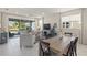 Bright living room with sliding glass doors leading to the backyard, a comfortable sofa, and a flat-screen TV at 8669 Rain Song Rd, Sarasota, FL 34238