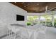 Outdoor kitchen with bar seating and built-in TV at 8669 Rain Song Rd, Sarasota, FL 34238