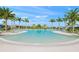 Relaxing freeform pool surrounded by palm trees at 8669 Rain Song Rd, Sarasota, FL 34238