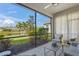 Screened patio overlooking a pond and lush landscape at 8669 Rain Song Rd, Sarasota, FL 34238