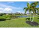 Scenic view of a pond and houses with lush landscaping at 8669 Rain Song Rd, Sarasota, FL 34238