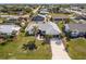 Aerial view of a single-Gathering home with a landscaped yard and driveway at 949 Chevy Chase St, Port Charlotte, FL 33948