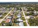 Aerial view of a residential neighborhood showing homes, streets, and lush greenery at 949 Chevy Chase St, Port Charlotte, FL 33948