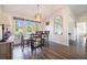 Charming dining room with a wooden table, chairs, and large windows at 949 Chevy Chase St, Port Charlotte, FL 33948