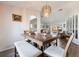 Bright dining area with wooden table and bench seating, overlooking living room at 949 Chevy Chase St, Port Charlotte, FL 33948