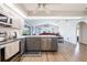 Modern kitchen with gray cabinets, stainless steel appliances, and breakfast bar at 949 Chevy Chase St, Port Charlotte, FL 33948