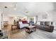 Open living room with gray sofas, wood flooring, and views into the kitchen at 949 Chevy Chase St, Port Charlotte, FL 33948