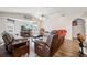Relaxing living room with leather sofas, a large TV, and a cozy fireplace at 949 Chevy Chase St, Port Charlotte, FL 33948