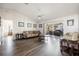 Open living room with hardwood floors, neutral decor, and view of backyard at 949 Chevy Chase St, Port Charlotte, FL 33948