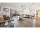 Bright living room with hardwood floors, comfy sofas, and access to a patio at 949 Chevy Chase St, Port Charlotte, FL 33948
