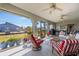 Relaxing screened porch with outdoor furniture and ceiling fans at 949 Chevy Chase St, Port Charlotte, FL 33948