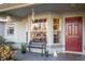 Inviting front porch with a bench, plants, and wind chimes at 9800 Horizon Dr, Spring Hill, FL 34608