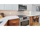 Modern kitchen featuring stainless steel appliances, a herringbone backsplash, and sleek white countertops at 101 S Gulfstream Ave # 5K, Sarasota, FL 34236