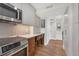 Modern kitchen featuring stainless steel appliances, a herringbone backsplash, and sleek white countertops at 101 S Gulfstream Ave # 5K, Sarasota, FL 34236