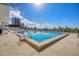 Large community pool with water view, lounge chairs and building exterior at 101 S Gulfstream Ave # 5K, Sarasota, FL 34236