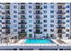 Condo features an outdoor pool and lounge area with tables, chairs, and umbrellas at 101 S Gulfstream Ave # 5K, Sarasota, FL 34236