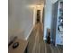 Long hallway with wood-look floors at 104 Carswell Cir # 10, Sun City Center, FL 33573