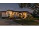 Well-lit home exterior with landscaping and driveway at 1060 Water Oak Ne Ct, St Petersburg, FL 33703